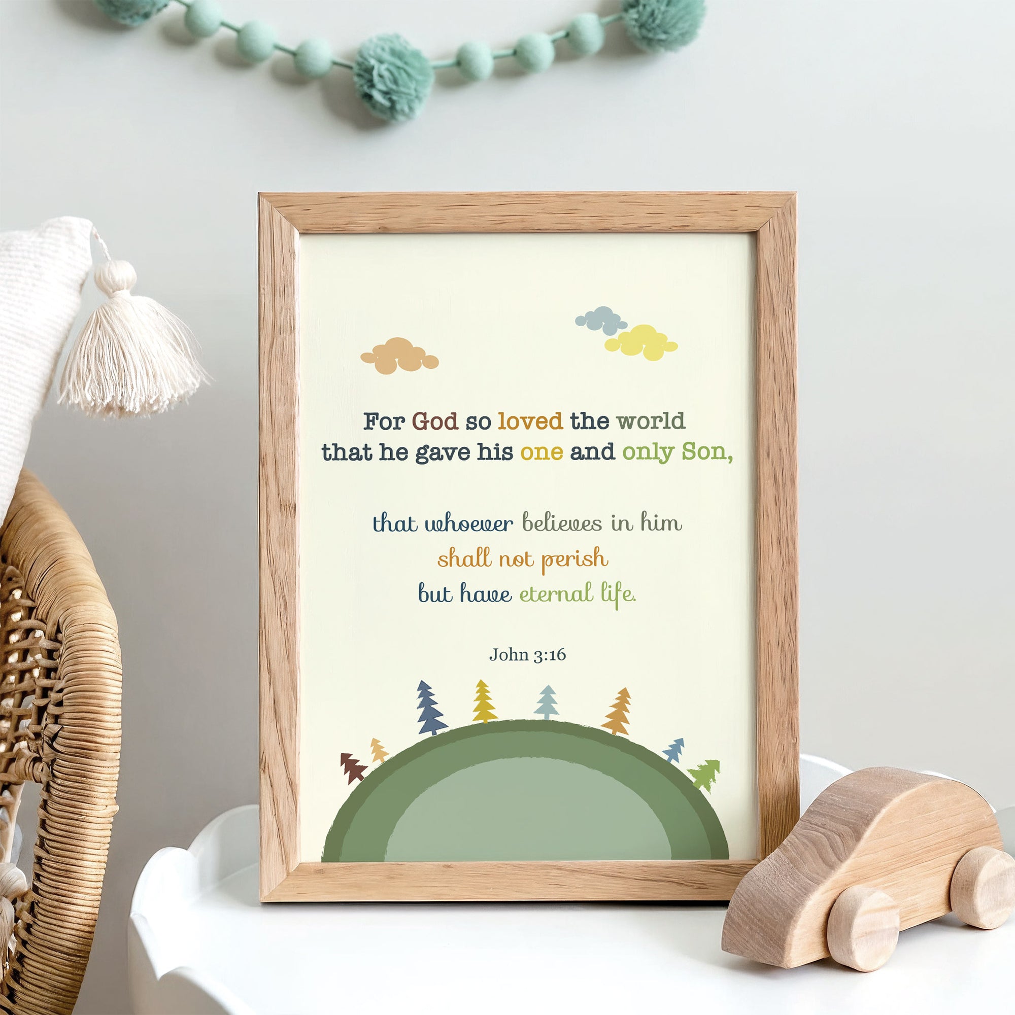 John 3:16 nursery wall art with earth and trees illustration displayed in a baby's room
