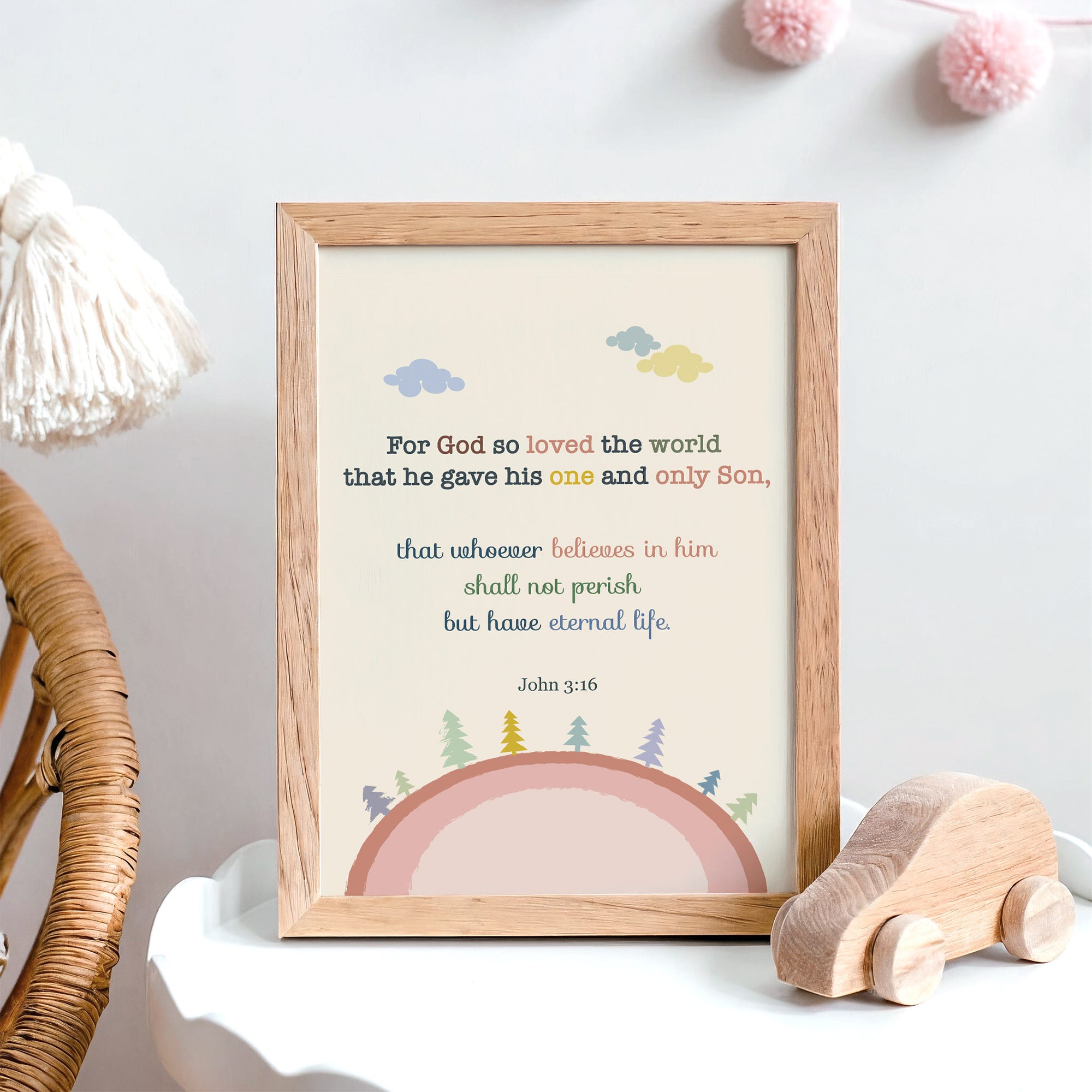 John 3:16 nursery wall art with pink earth and trees illustration displayed in a baby's room