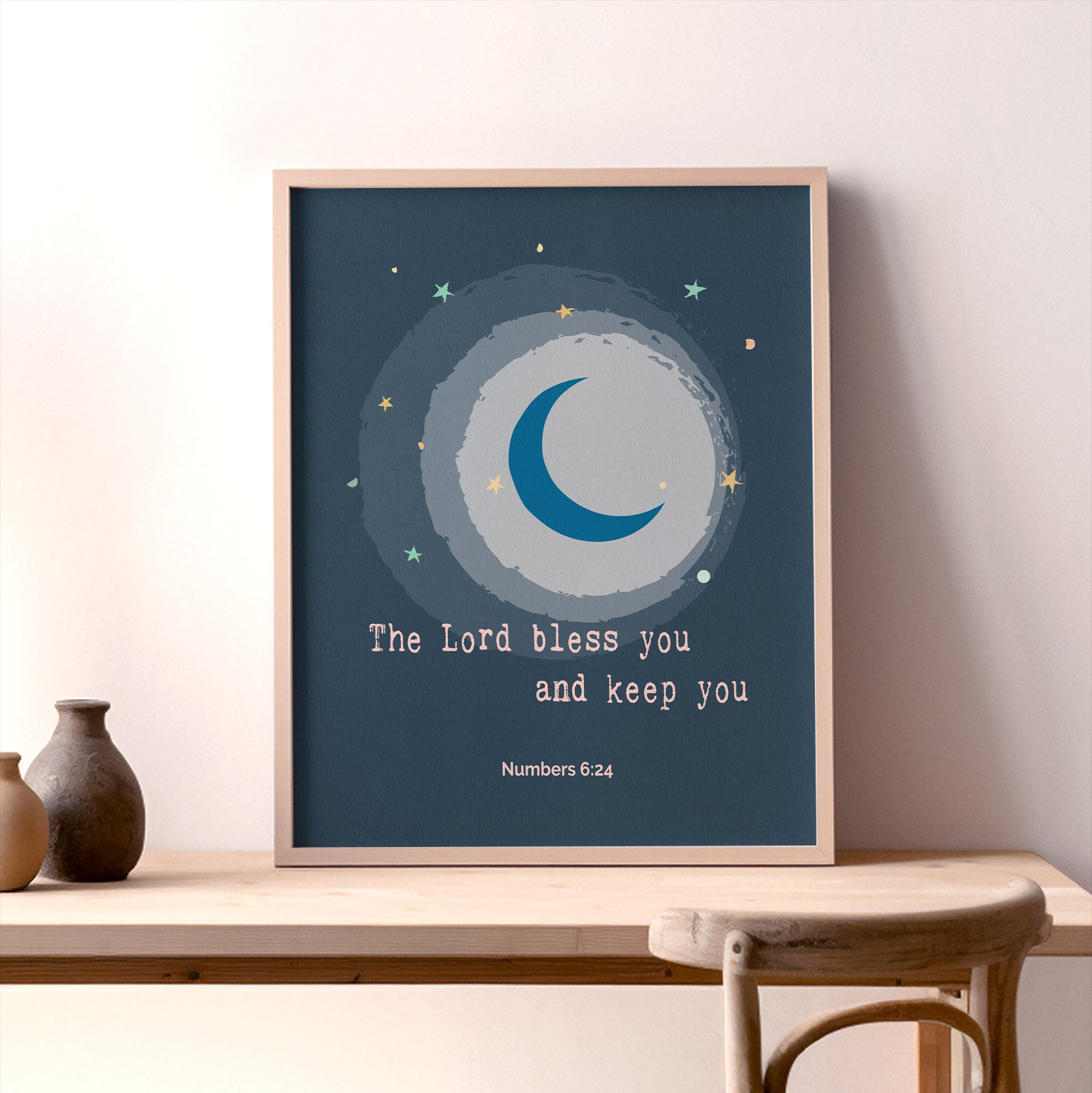 Moon and star nursery wall art with Numbers 6:24 blessing displayed in a baby's room