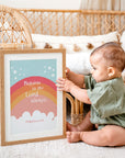 Orange rainbow Philippians 4:4 Bible verse wall art displayed in modern nursery with baby